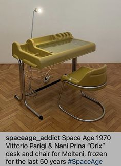 a yellow chair sitting next to a desk on top of a hard wood floor