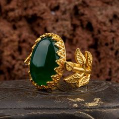 Green Aqeeq Flower Gold Plated Silver Women Ring. Handmade in 925 gold color plating sterling silver with agate stone. On the ring Oval Green Aqeeq - Agate stone settled. At sides, flower figure settled with micro detailed ornament. Dimensions of stone is 20 mm x 15 mm. Average weight of Green Aqeeq Flower Gold Plated Silver Women Ring is 9 gr. (depends your ring size). Back side is open and stone touches your skin. Classic and exclusive style. Stone Type: Aqeeq - Agate Stone Color: Green Stone Gold Agate Hallmarked Jewelry, Elegant Gold Emerald Ring With Natural Stones, Gold Chalcedony Jewelry For Anniversary, Silver Locket Necklace, Classic Earrings, Silver Chain Bracelet, Silver Lockets, Exclusive Jewelry, Handmade Rings