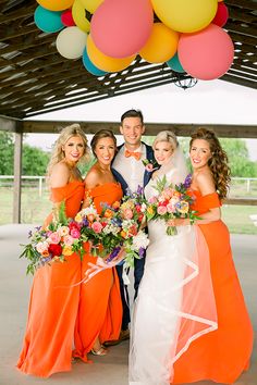 the bride and groom are posing with their bridal party friends in front of balloons