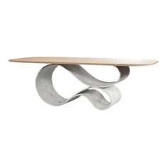 a table with a wooden top and curved metal design on the bottom, against a white background