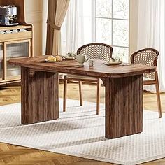 a dining room table with chairs and a microwave oven in the corner next to it