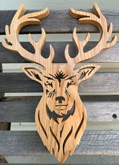 a wooden deer head mounted to the side of a bench