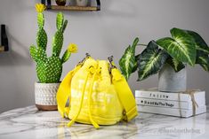 Style: Marc Jacobs The Bucket Bag (Yellow) Material: Soft Terry Fabric Features: Adjustable/Detachable Crossbody Strap, Inner Zip and Slip Pockets, Drawstring Closure, Ultra Soft Plus Exterior and Interior Measures: 6.3" W x 8.3" H x 6.3" D MSRP: $295 Bucket Bag Marc Jacobs, Yellow Bucket Shoulder Bag With Detachable Handle, Yellow Leather Crossbody Bucket Bag, Yellow Bucket Bag With Gold-tone Hardware, Marc Jacob’s Bucket Bag, Pantone Colour Palettes, Terry Fabric, Spring Fling, Pantone Color