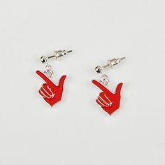 pair of red and silver colored earrings with hand symbol on them, against white background