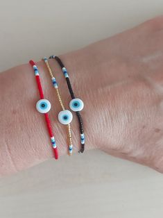 This beautiful, minimal, unisex bracelet was made using high quality miyuki beads and rope. In the middle there is a  evil eye. It is adjustable with a sliding knot macrame closure. Friendship bracelet is minimalist. You can use it comfortably with any dress. Gives you a great view with your other bracelets. The price given is for three (3) bracelet. Use your bracelet every day to protect yourself from bad shyness and negative energy. Combine them to fit your personal style. Charm bracelet is an Minimalist Adjustable Beaded Bracelets With Evil Eye, Minimalist Beaded Bracelet With Evil Eye For Gift, Minimalist Evil Eye Beaded Bracelets As Gift, Bracelets Evil Eye, Knot Macrame, Miyuki Bead, Protection Jewelry, Christmas Engagement, Good Luck Bracelet