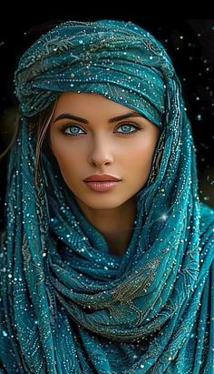 a woman with blue eyes wearing a turquoise scarf