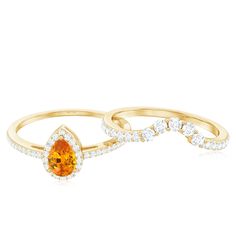 two gold rings with orange and white diamonds