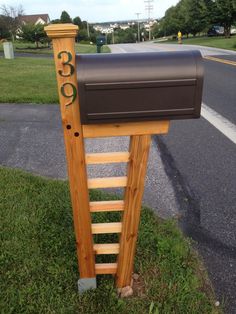 a mailbox on the side of a road with a ladder going up to it