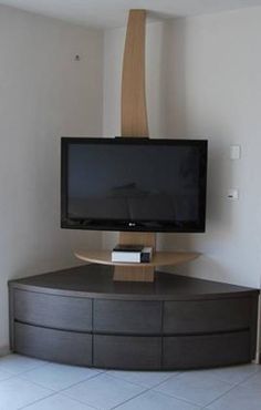 a flat screen tv sitting on top of a wooden stand