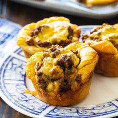 some tasty looking muffins on a blue and white plate with other food items in the background