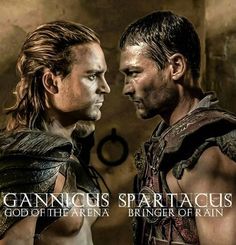 two men standing next to each other in front of a sign that says gannicus sparta