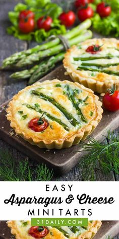 asparagus and cheese mini tarts on a cutting board with vegetables in the background