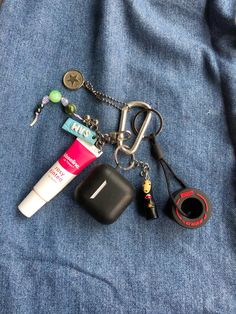 updated my keychain!                                        lip balm + airpods + kaonashi (no face) + f1 pirelli tires Carabeaner Keychain, Keychain With Keys, Carabiner Keychain Aesthetic, F1 Keychain, Bag Keychain Aesthetic, Key Chains Ideas, Key Chains Aesthetic, Car Keys Keychain Ideas, School Bag Keychain