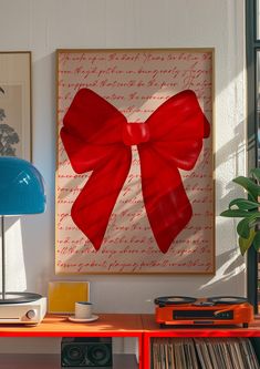 a red bow is hanging on the wall next to a record player and stereo system