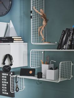 there are two shelves that have books, headphones, and other items on them