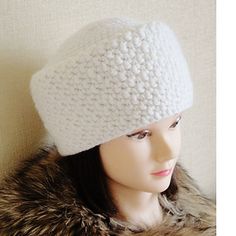 a mannequin head wearing a white knitted hat with faux fur trims