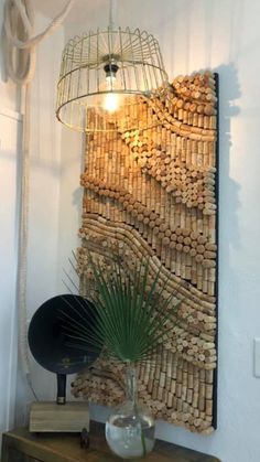 a room with a lamp and some wine corks on the wall next to a potted plant