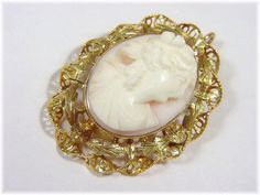 "@@ FREE SHIPPING WITHIN USA @@ 10K Gold Victorian Shell CAMEO Pendant - Twisted Ribbon Black Hills Gold Filigree Frame - Valentines Day Christmas Gift - FREE SHIPPING. Cameo Brooch, Wedding Jewelry, Linen Lace, Cameo Jewelry, Cameo Brooch, Sardonyx Shell, Estate Jewelry, Etruscan, Edwardian, Intaglio, Silhouette. 10K Gold Victorian Shell CAMEO Pendant. Williamsburg is a magical town with many a Treasure to be found. This Victorian Treasure came from an old Historical Estate who ancestors date b Victorian Style Cameo Brooch For Weddings, Victorian Cameo Brooch For Wedding, Heirloom Cameo Brooch For Wedding, Heirloom Cameo Brooches For Weddings, Heirloom Cameo Wedding Brooch, White Cameo Brooch For Wedding, White Cameo Brooches For Wedding, Heirloom White Brooch For Formal Occasions, White Cameo Wedding Brooches