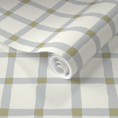 a white and green checkered wallpaper with a rolled up roll on it's side