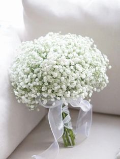 a bouquet of baby's breath sitting on a couch