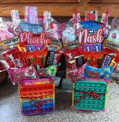 two baskets filled with candy and candies on top of a counter next to each other