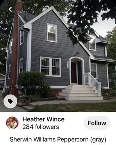 a gray house with white trim and windows