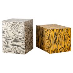 two wooden cubes sitting side by side on top of each other in different colors