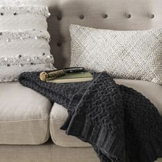 a couch with a blanket and pillows on it