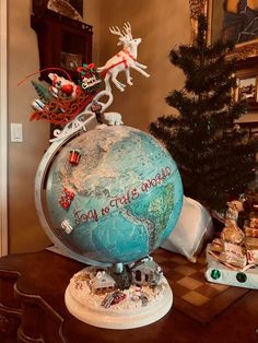 a globe with christmas decorations on top of it