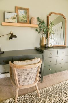 a chair and desk in a room with pictures on the wall