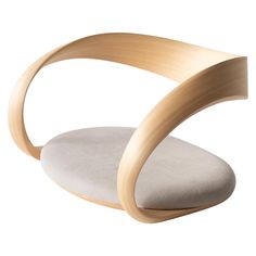 the curved chair is made from wood and fabric