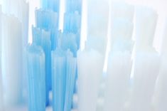 several blue and white toothbrushes lined up together