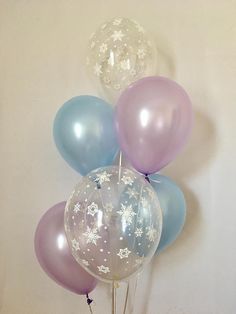 a bunch of balloons with snowflakes on them