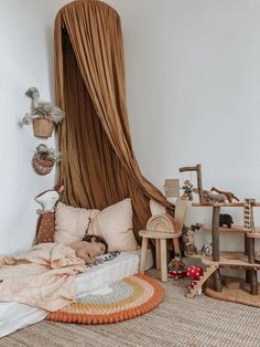 a child sleeping on a bed in a room with lots of stuffed animals and toys