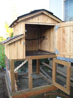 a chicken coop built into the side of a house