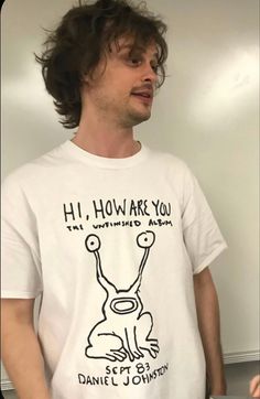 a man with long hair wearing a t - shirt that says hi, how are you?