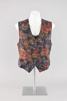 Vintage fitted vest in dark red, orange, green and blue tones. All over romantic floral pattern with a dotted paint brush overlay.   Small glossy brown colored buttons down the front. Two faux pocket flaps for visual interest. Has a tied back for custom fit.  Lightweight, smooth blend of polyester and wool fabric. The inside is lined in silky red polyester fabric for comfort.  Brand Lucia Petites // Made in USA // 80s - 90s era Condition Great condition No rips, tears or stains *Contains Wool Ma Fitted Retro Red Vest, Retro Red Fitted Vest, Retro Red Cotton Vest, Fitted Vintage Multicolor Vest, Vintage Beaded Vest, Waistcoat Top, Vintage Floral Print Sleeveless Vest, Red Waistcoat, Fitted Vest