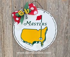 a sign that says masters with a bow on it's head hanging from a wooden fence