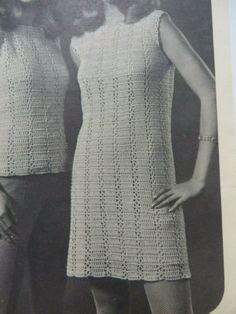 an old photo of two women standing next to each other wearing short skirts and crocheted dresses