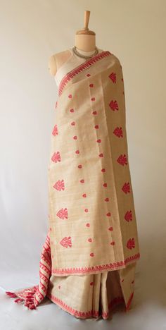 This is hundred percent authentic Muga Silk Saree . It has Muga silk in the warp and weft .   The interwoven motif yarns are in mercerised cotton  The design is the traditional red with muga silk and can be considered as bridal . The red and Muga combination is the classic design pattern that is most associated with Muga Silk .  Muga Silk - The most valued silk from India. Almost exclusively reared and produced in Assam, India. It is indigenous to the Brahmaputra Valley and assiduously practiced Red Fabric With Traditional Patterns And Drape, Red Fabric With Traditional Patterns, Red Cotton Dupatta With Zari Weaving, Red Cotton Saree With Weaving Work, Red Embroidered Fabric With Woven Motifs For Festive Occasions, Red Cotton Dupatta With Woven Motifs, Unstitched Red Saree With Woven Motifs, Red Cotton Traditional Wear With Woven Motifs, Red Cotton Traditional Wear With Weaving Work