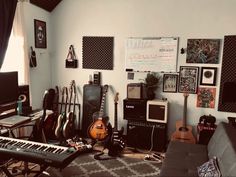 a room filled with musical instruments and guitars