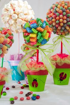 there are many colorful candies in the cupcakes on the table with candy