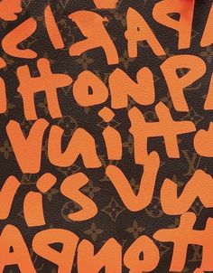 an orange and black background with letters on it