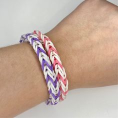 a person's arm with two different colored bracelets on it