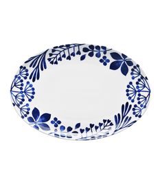 a blue and white plate with floral designs on the rim, against a white background