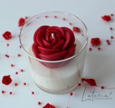 a red rose sitting in a glass filled with milk