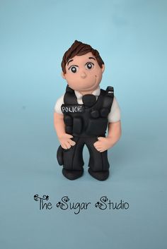 a figurine of a police officer is posed on a blue background with the caption, the sugar studio