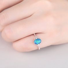 You are looking at a vintage Lab-created blue opal and diamond engagement ring.A perfect anniversary gift, birthday gift,wedding engagement ring. Ring Information Main Stone *Lab-created blue opal *6x8mm oval cut *Weight:it's approx 1.5 ct. *Setting: 4-prongs Side Stone *0.18 carat natural diamond Metal * Solid 10k 14k &18k. *Color:white gold,yellow gold,rose gold. Custom Order *The main stone can be other gemstones you can imagine,any birthstone can be made.Please contact me if you need thi Oval Opal Promise Ring, Blue Opal Round Ring, Blue Round Opal Ring, Blue Oval Opal Ring Fine Jewelry, Oval Opal Promise Ring With Accent Stones, Oval Opal Ring With Accent Stones, Blue Oval Opal Ring Gift, Oval Opal Promise Ring With Birthstone, Oval Opal Birthstone Ring For Promise