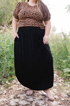 Effortlessly elegant and versatile, the Jocelyn Maxi Skirt is a must-have for any wardrobe. Crafted from a lightweight fabric, its maxi length and split sides provide a flowy and flattering fit. The elastic waist ensures comfort all day long. Embrace your inner goddess with this stunning skirt! The split sides measure 19"-20" from the top of the waistband. Fits true to size. Model is wearing a 1X and is 5'7". Size Chart Length Waist 1x 40" 38" 2x 40" 40" 3x 40" 44" *Measurements are approximate Versatile Flowy Lined Maxi Skirt, Flowy Rayon Maxi Skirt, Stretch Maxi Skirt For Day Out, Maxi Length Rayon Skirt With Elastic Waistband, Chic Black Maxi Dress With Elastic Waistband, Solid Rayon Maxi Skirt With Lining, Solid Rayon Lined Maxi Skirt, Solid Color Rayon Maxi Skirt With Lining, Flowy Solid Color Maxi Skirt For Day Out