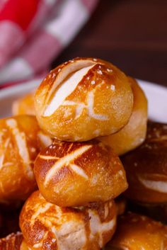 a pile of bread rolls sitting on top of a white plate